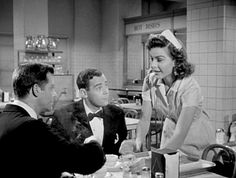 an old black and white photo of three people sitting at a table in a restaurant