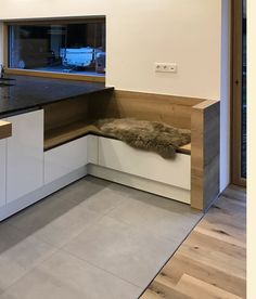 a kitchen with white cabinets and black counter tops