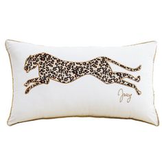 a white pillow with a black and gold cheetah print on the front of it