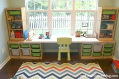 a child's playroom with toys and bookshelves in the window sill