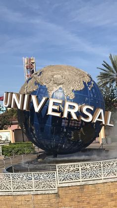 the universal sign in front of a building with a large globe on it's side