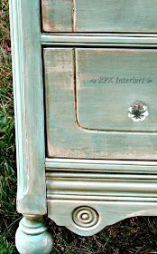 an old dresser is painted green and has writing on the bottom drawer that says,