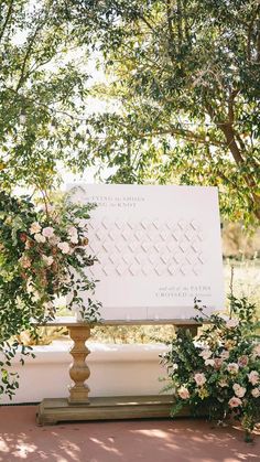 an outdoor ceremony setup with flowers and greenery