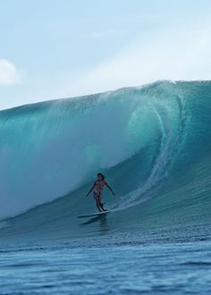 a man riding a wave on top of a surfboard