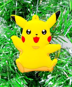 a yellow ornament with a pikachu on it hanging from a christmas tree