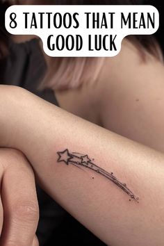 a woman's arm with the words 8 tattoos that mean good luck