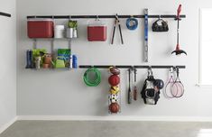 there are many sports equipment hanging on the wall