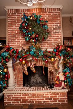 a fireplace decorated for christmas with ornaments and wreaths on the mantel above it