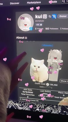 someone is holding their hand up to the screen with an image of a cat on it