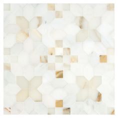 an image of a white tile wall with gold and brown squares in the center, as seen from above