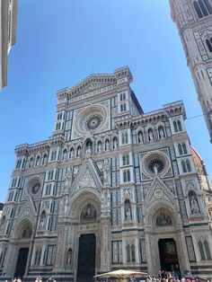 people are standing in front of the cathedral