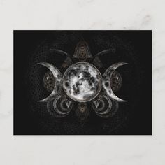 three phases of the moon in black and white with an intricate design on it's side