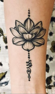 a woman's leg with a tattoo on it and a flower in the middle