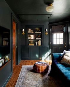 a living room filled with furniture and bookshelves