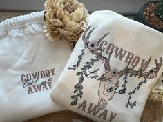 "Cozy up in our western \"Cowboy Take Me Away\" Lounge Set! The design is completely hand drawn and is the perfect western gift for family, friends, and for yourself! The \"Cowboy Take Me Away\" Lounge Set includes a crewneck and sweatpants. The lettering is printed on the front corner of the shirt, while the deer skull and flower drawing is printed on the back of the crewneck. For the sweatpants, the lettering is printed on the front of the sweatpants. SIZING: Sizes S-3X are available. Please see our product photos for our measurement chart. MATERIAL: A 50% polyester / 50% cotton blend of pure comfort and softness!  Shop through our \"Crewnecks\" section to browse our everyday crewneck styles, our \"Lounge Sets\" section to browse other other lounge sets/pajamas! Stay Connected with Simpl Skull And Flower Drawing, Boho Deer Skull, Country Relationships, Cowboys Hoodie, Santa Pajamas, Christmas Pjs Family, Western Sweatshirts, Cute Christmas Sweater, Western Gifts