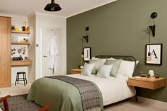 a bedroom with green walls and white bedding