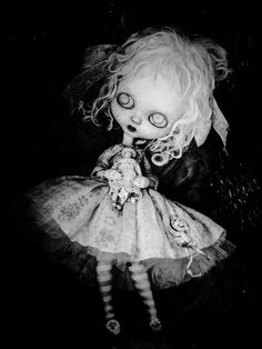 a black and white photo of a creepy doll