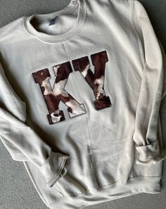 These Kentucky sweatshirts are super comfy as well as the perfect touch with boots and jeans!  Nothing says FALL like our cow print KY sweatshirts! Sweatshirts are unisex and can be done in ANY state abbreviation and sweatshirt color can be changed!  ❗️Sizes: Toddler-2T-5T  Youth XS-XL  Adult S-XL  Adult 2X- Adult 3X  The sweatshirt has a brown cow print KY stitched onto the black sweatshirt.  If you would like to request a custom order, please send us a message!! Kentucky Sweatshirt, State Abbreviations, Letter Sweatshirt, Cow Print, Printed Sweatshirts, Custom Orders, Letter Prints, Sweatshirts Women, Cow