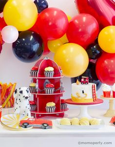 a birthday party with balloons, cake and cupcakes