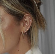 a close up of a person wearing ear piercings