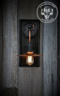 a light that is on the side of a wooden wall next to a lamp fixture