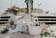 the table is set up with flowers and candles on it, along with other decorations