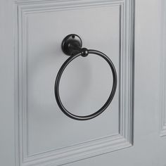 a black towel ring on a white door