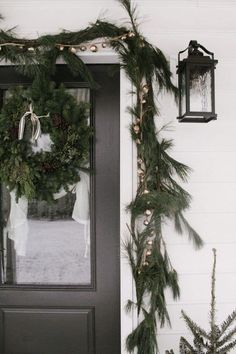 the front door is decorated for christmas with wreaths and pine cones on it's side