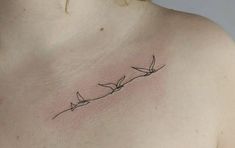 the back of a woman's shoulder with birds on it