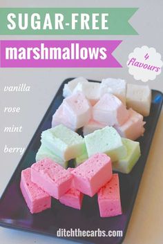 sugar - free marshmallows on a black plate with pink and green squares