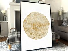 a living room filled with furniture and a large framed tree stump art print on the wall