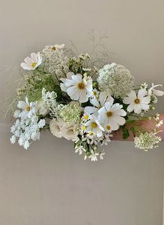 a hand holding a bouquet of white flowers