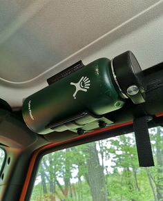 the inside of a vehicle with trees in the background