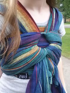 a woman wearing a multicolored striped scarf