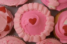 cupcakes with pink frosting and hearts on them