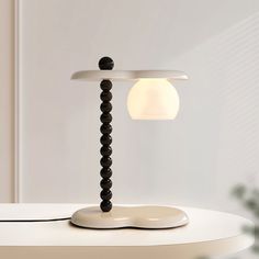 a white table with a lamp on top of it