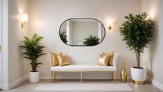 a white couch sitting under a round mirror next to potted plants