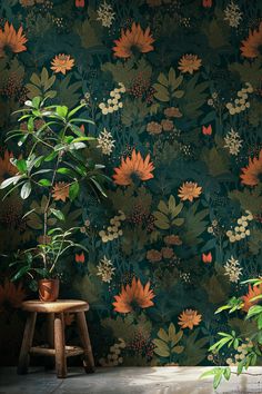 a green wallpaper with orange and yellow flowers in the corner next to a wooden stool