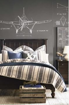 a bed room with a neatly made bed and an airplane drawn on the wall