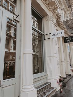 a white building with a sign in front of it that says cleine on the outside