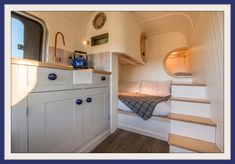 the interior of a tiny house with stairs leading up to it's bed area