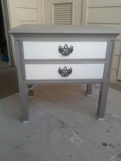 a white and grey dresser sitting on top of a floor