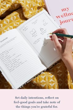 a person writing on a notebook with a notepad and pen next to it that says set daily intentions, reflect on feel - good goals and take note of the things you're grateful