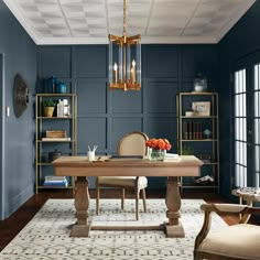 an elegant dining room with blue walls and gold accents