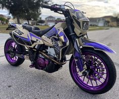 a purple and black motorcycle parked on the street