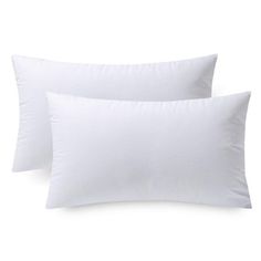 two white pillows sitting next to each other