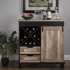 a wooden cabinet with wine bottles and glasses on it