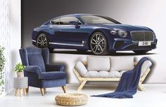 a blue car is sitting in the middle of a room with white walls and furniture