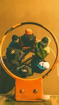 a group of snowboarders sitting in the middle of a hula hoop on top of a table