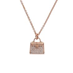 This Necklace is in 18k rose gold with a rose gold Kelly bag pendant set with 38 round brilliant diamonds with a .39 ct weight. Origin: France Condition: Pristine; new or never worn Accompanied by: Hermes box, brown jewelry box and ribbon Measurements: Length: 16 in, Pendant 18mm x 11mm Luxury Rose Gold Pendant Necklace, Kelly Ripa Necklace, Hermes Accessories Jewelry, Hermes Jewelry Necklace, Hermes Collection, Hermes Necklace, Hermes Jewelry, Hermes Accessories, Brown Jewelry